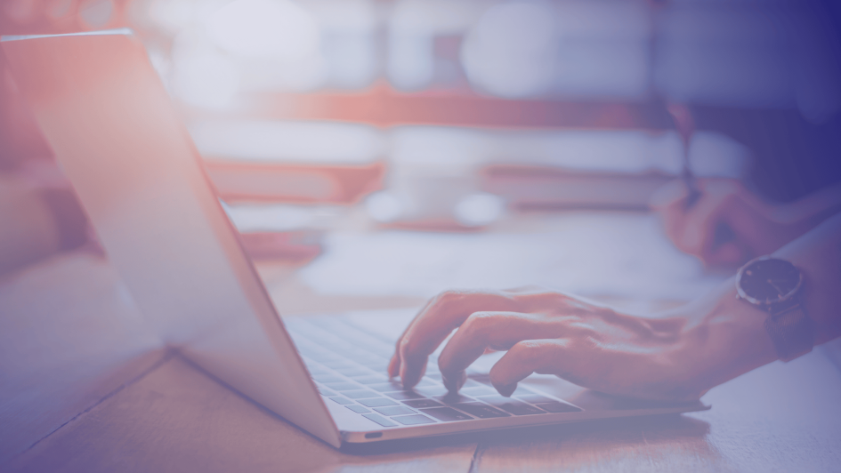 A promotional graphic for a blog post titled "Human Risk Management: Your Questions Answered" by Bigfish Technology. The left side features white text on a dark blue background alongside the Bigfish logo, while the right side shows a close-up of a person typing on a laptop with a notepad and pen in the background, suggesting a professional, information-focused setting.